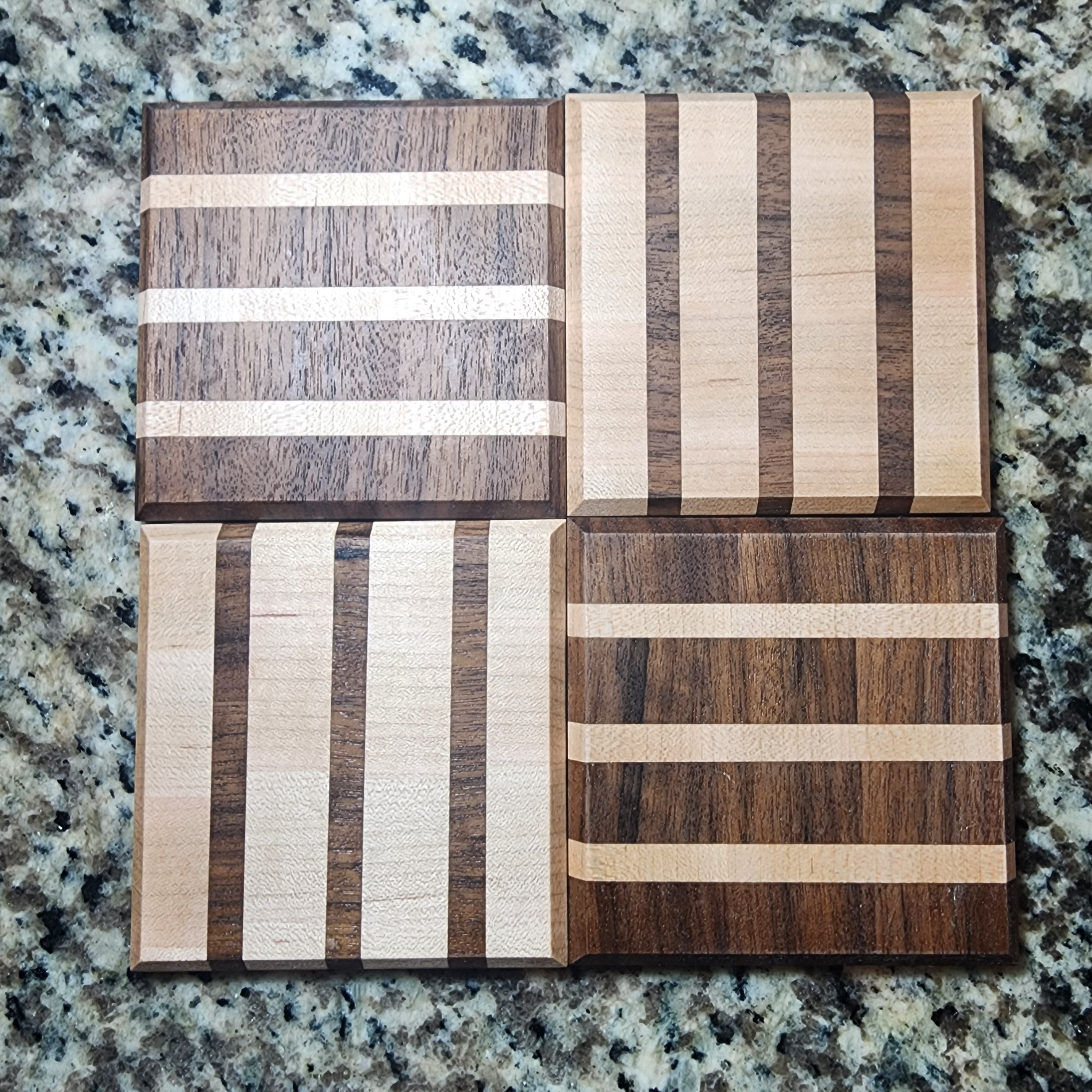 4pk Maple and walnut alternating pattern coasters. 2 coasters are maple with walnut lines and the other two are walnut with maple lines.