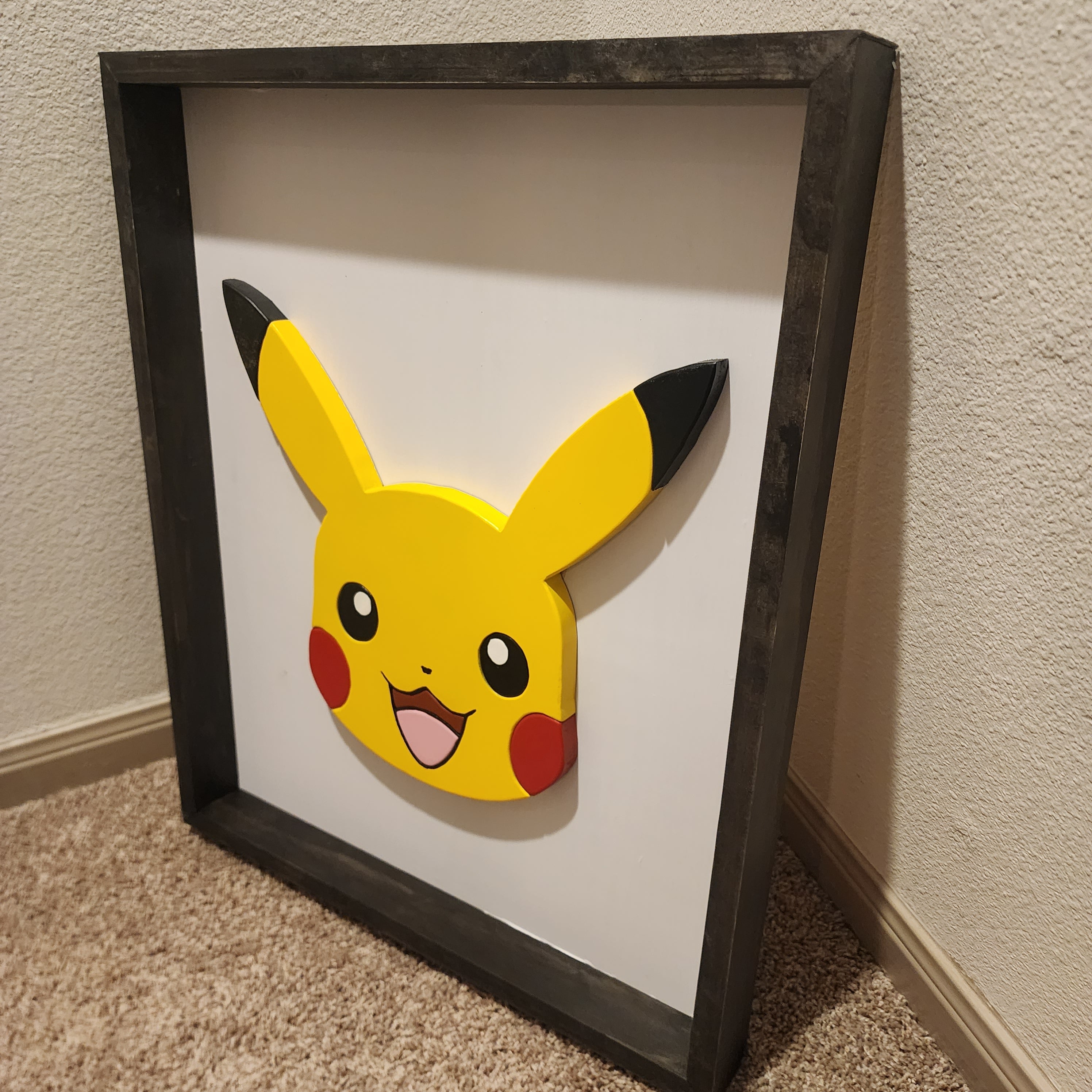 Angle view of Pikachu wall art. Cut with scroll saw and hand painted with acrylic paint.