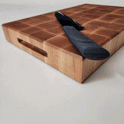 2 Inch End Grain Maple Cutting Board with knife and side view of finger grip