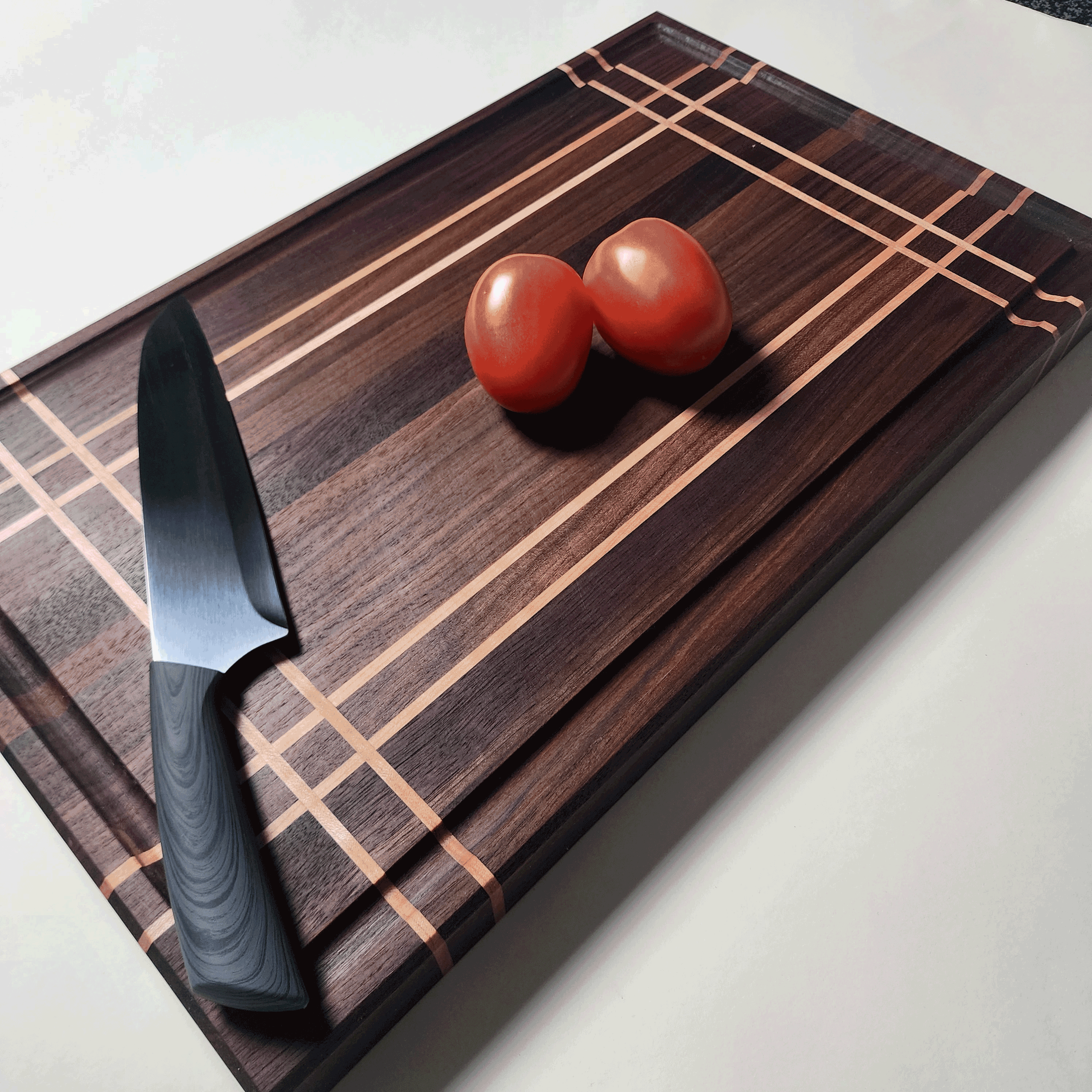 Beautifully crafted walnut cutting board with maple stripes. This board is 1.5 inches thick making a stable and reliable cutting board.