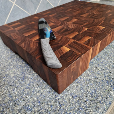 Custom 3" Walnut end grain cutting board made for customer. Knife on top for perspective. Features cutout on bottom to fit plates in.