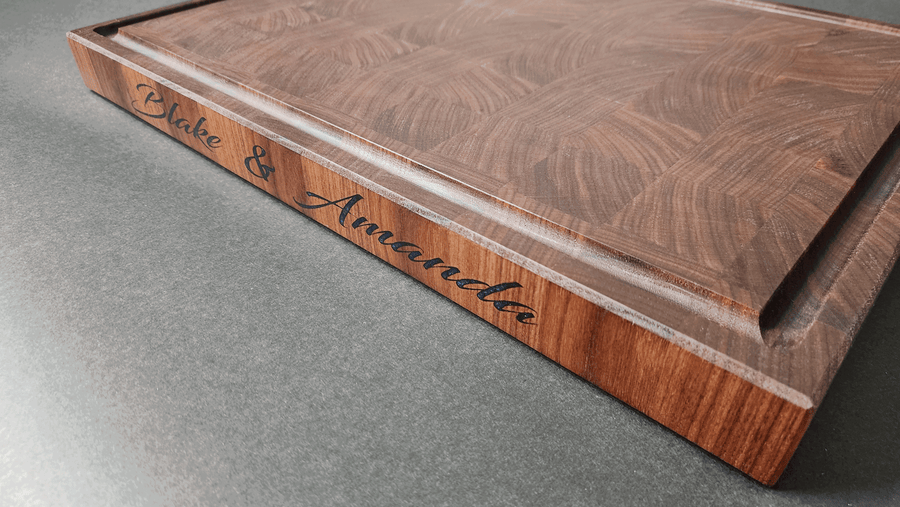 Personalized Walnut End Grain cutting board with color filled lettering on side of board