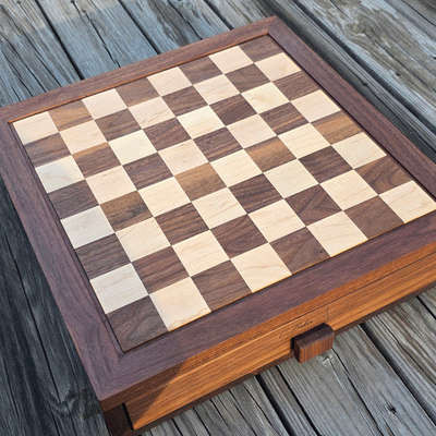 Custom chess board with 2 inch maple and walnut squares. Custom drawer and end graving on dark walnut